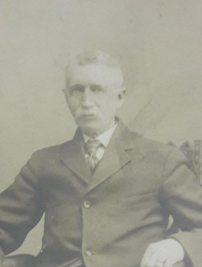 Harvey Lyman Chaffee seated in a wooden chair, an old studio photograph