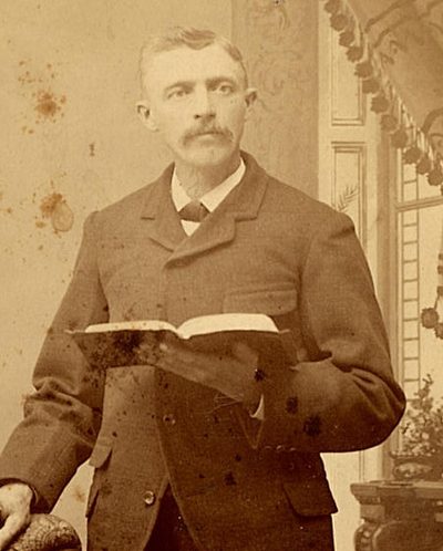 Stephen Chaffee standing with an open book, a cabinet card portrait