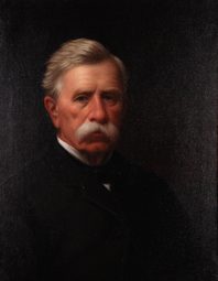 Self-portrait of a gray-haired man with a white mustache, in a dark coat, against a dark ground