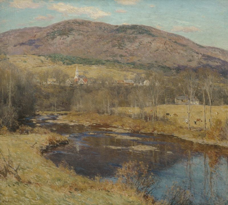 A river valley with a village and a bare mountain in early spring