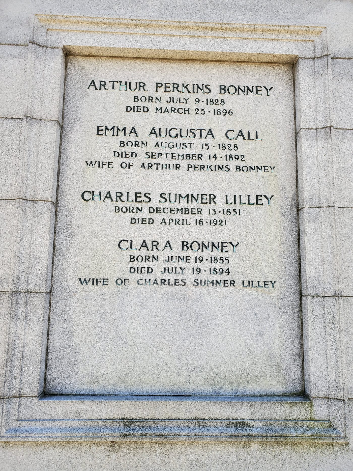 A granite panel inscribed with four names and dates: Arthur Perkins Bonney, Emma Augusta Call, Charles Sumner Lilley, Clara Bonney