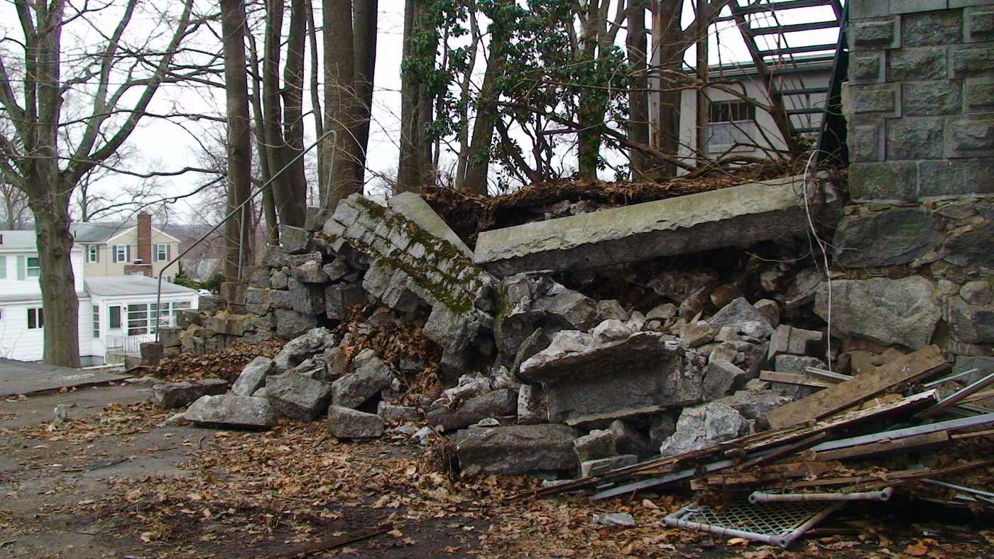 Debris and a damaged retaining wall