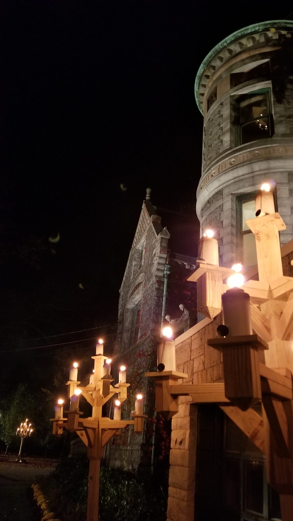 Close-up of a burning candelabra against the tower
