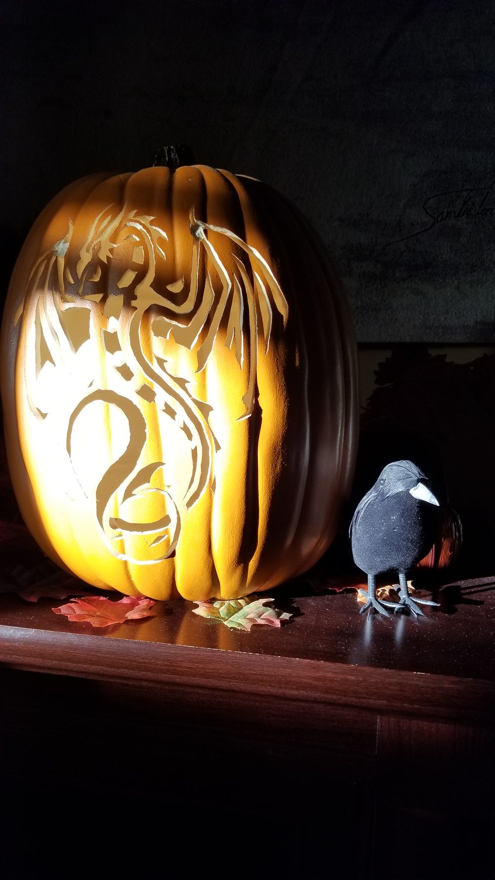 A carved pumpkin with a crow