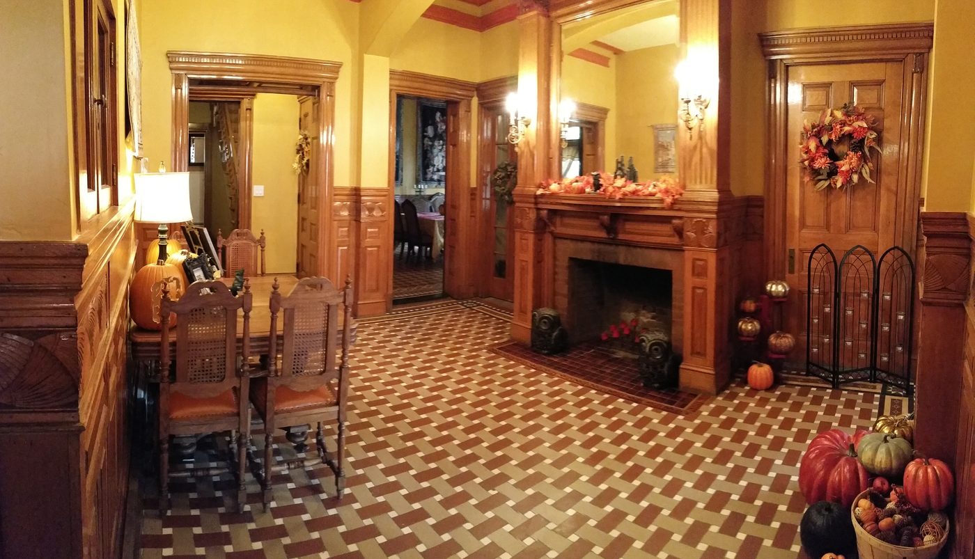 The entry-hall fireplace dressed for autumn