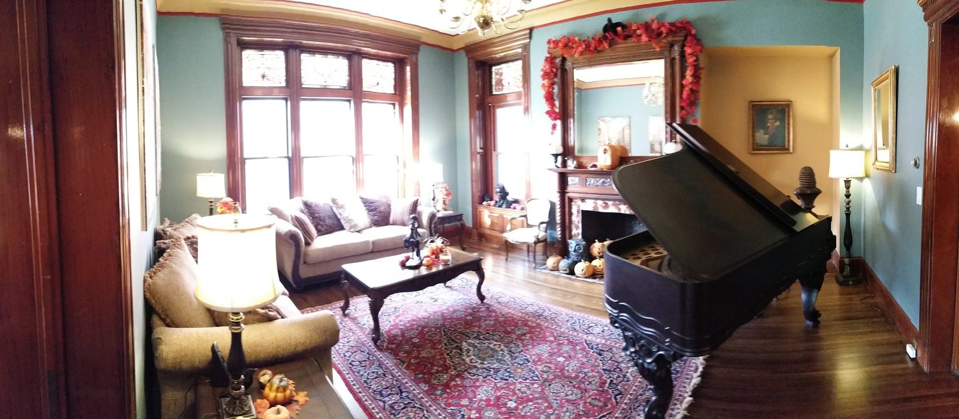 The music room with a grand piano and holiday garland
