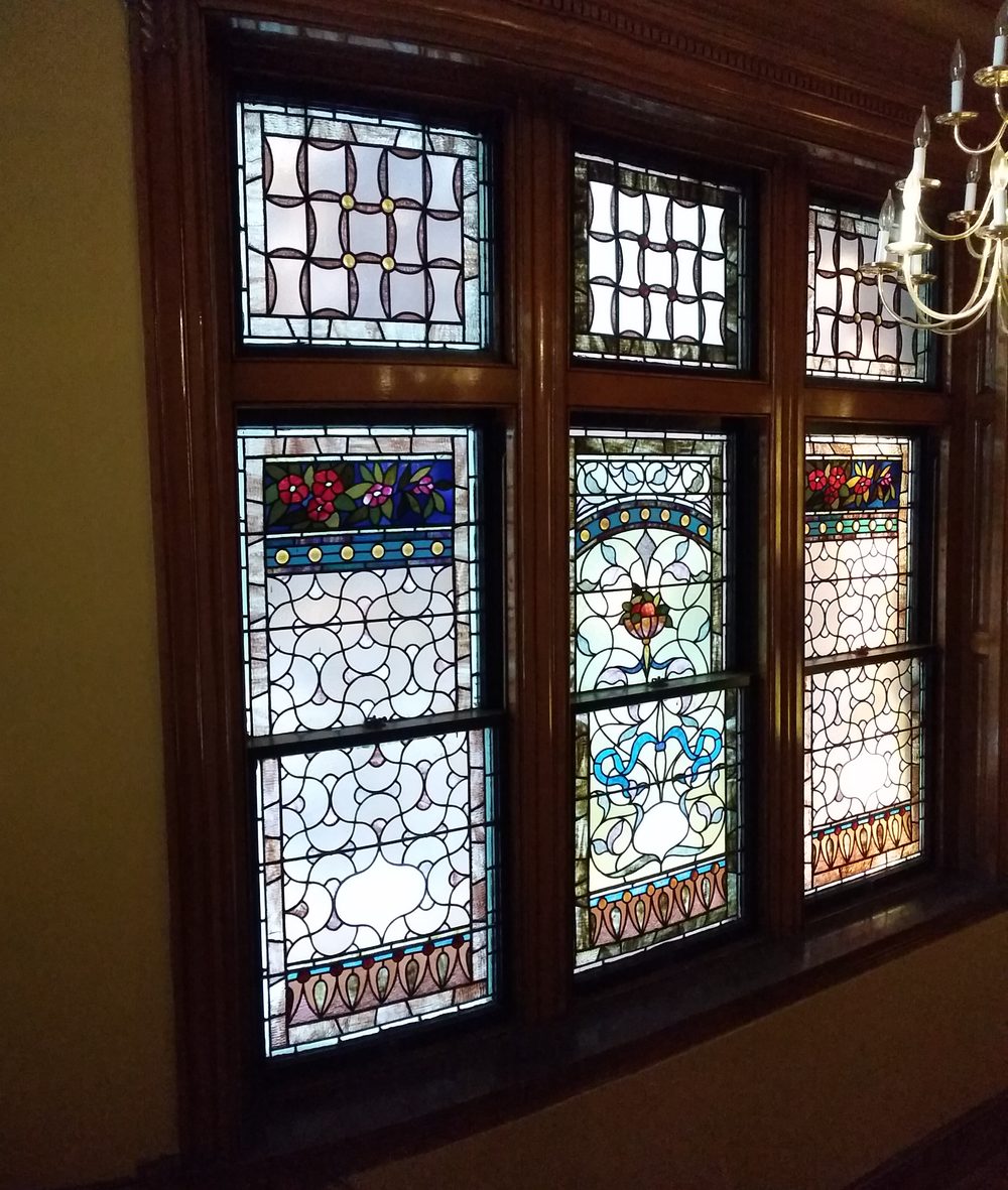 Stained-glass windows in daylight with a chandelier