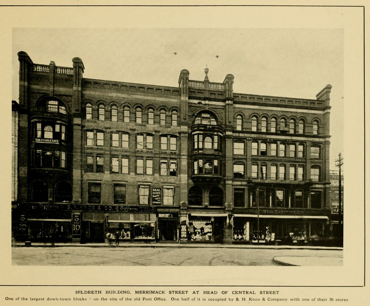 A large five-story commercial block with bay windows and storefront awnings