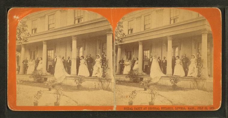 Stereograph of a wedding party gathered on a long columned porch, the bride in white at the center