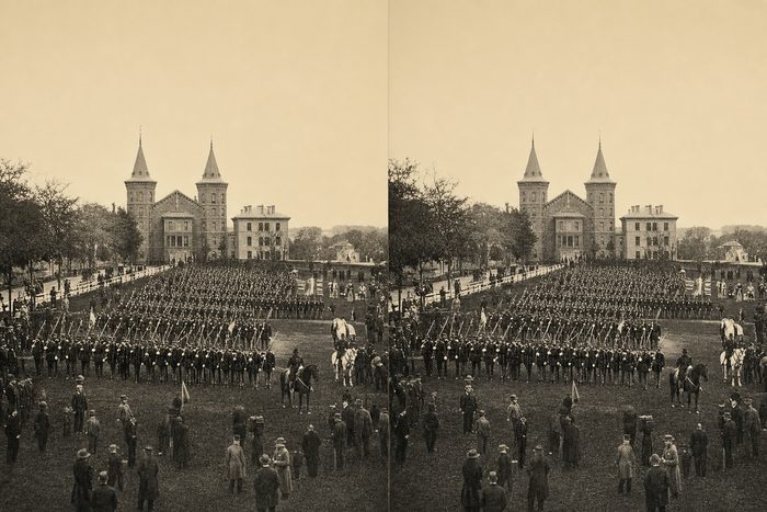 Stereograph of ranks of soldiers drilling on a common, with a towered building in the distance