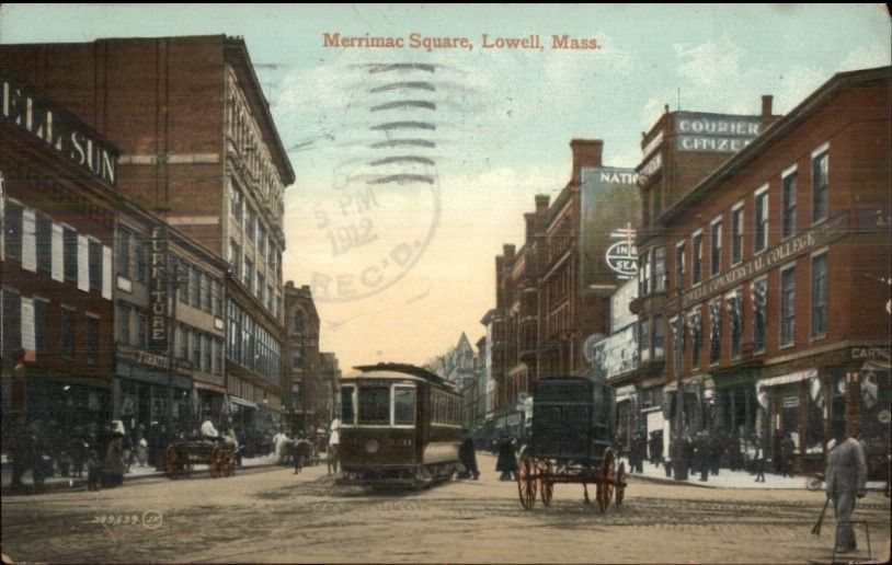 A color postcard of a city square with a streetcar, a horse-drawn wagon and tall brick buildings