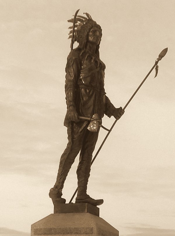A statue of a Native leader in a cemetery