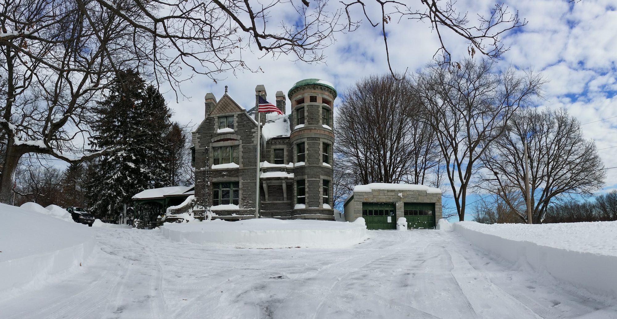 Panoramic winter view of the house and garage